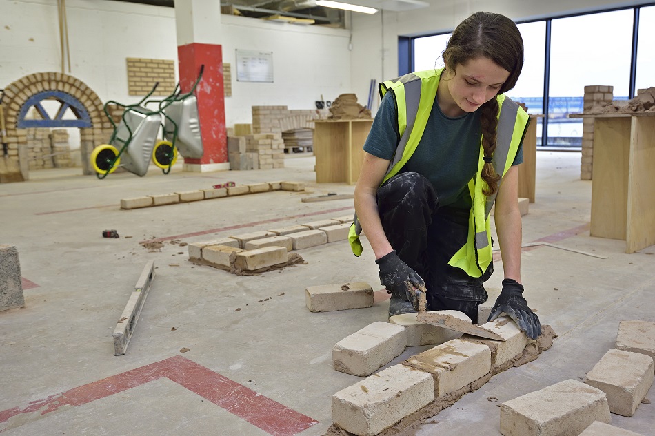 Female Wirral Met Bricklaying Student  working in a classroom