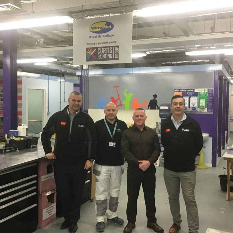 four men stood in the painting and decorating workshop at Wirral Met College