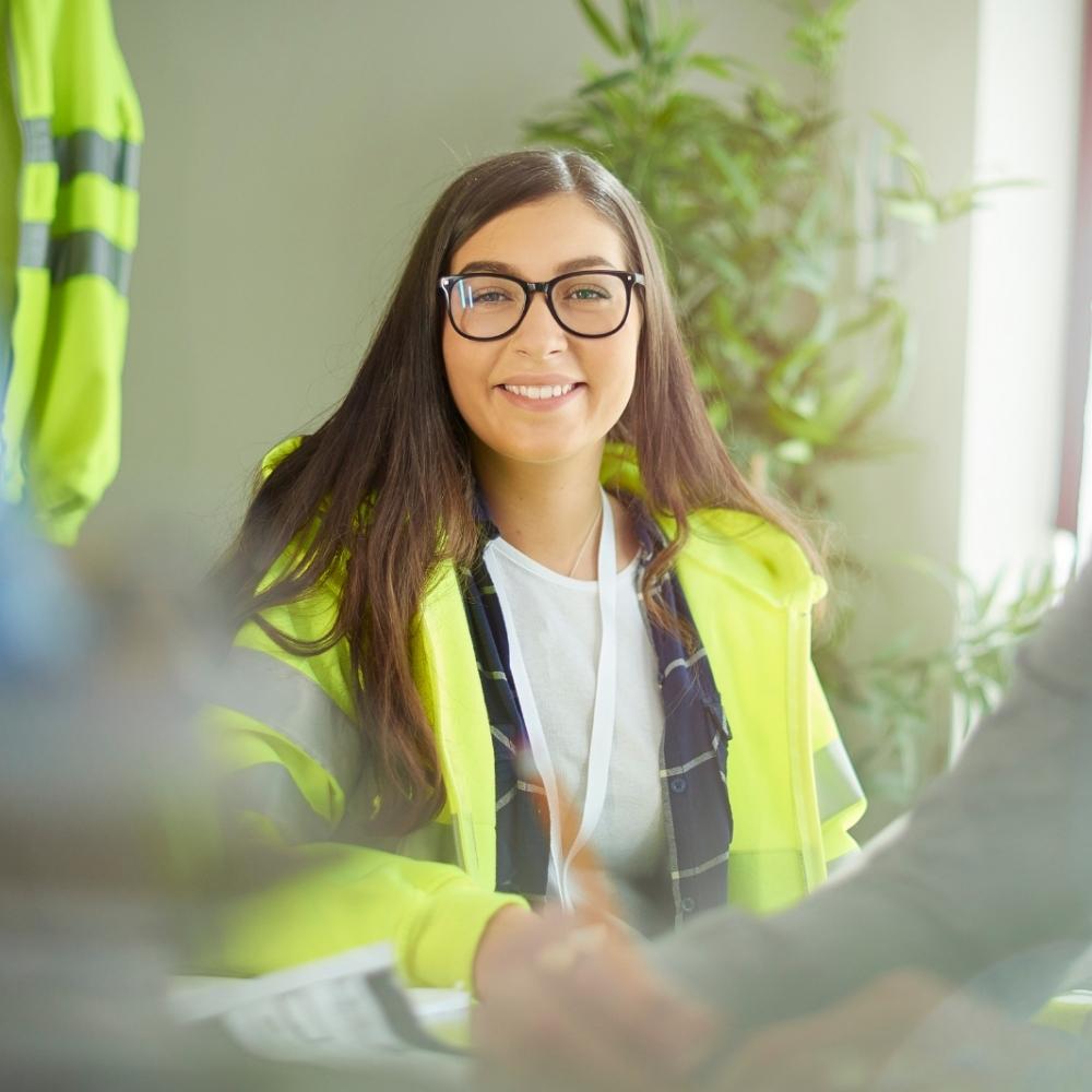 office worker in high visibility health and safety vest