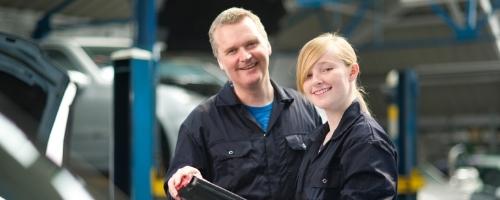 female mechanic apprentice with tutor