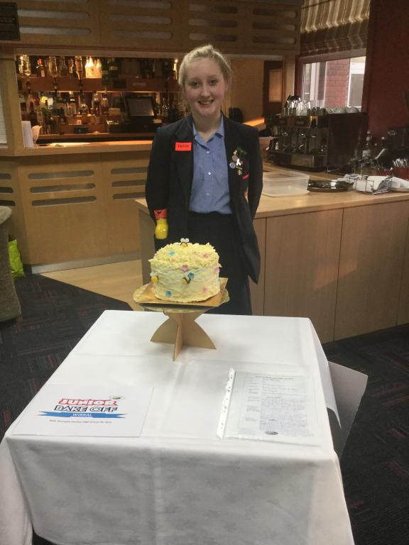 Beth Shimwell from Prenton High School standing in front of her cake with the theme of Bee Keeping at the Bake Off 2017
