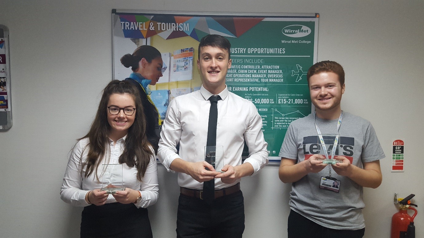 Three Travel and Tourism Students holding up their Erasmus+ Awards