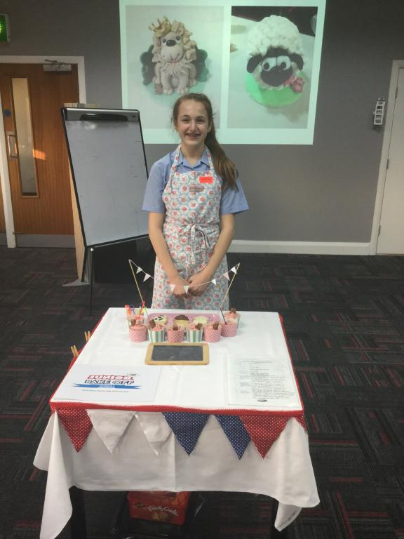 Olivia Gleave from Prenton High School standing in front of her ice cream flavoured cup-cakes celebrating Parkgate at the Bake Off 2017