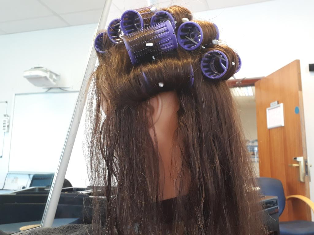 Wirral Met Hair and Beauty student with rollers in her hair