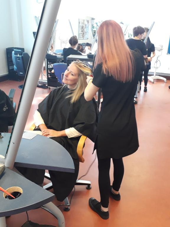 Wirral Met Hair and Beauty student working on Female student's hair