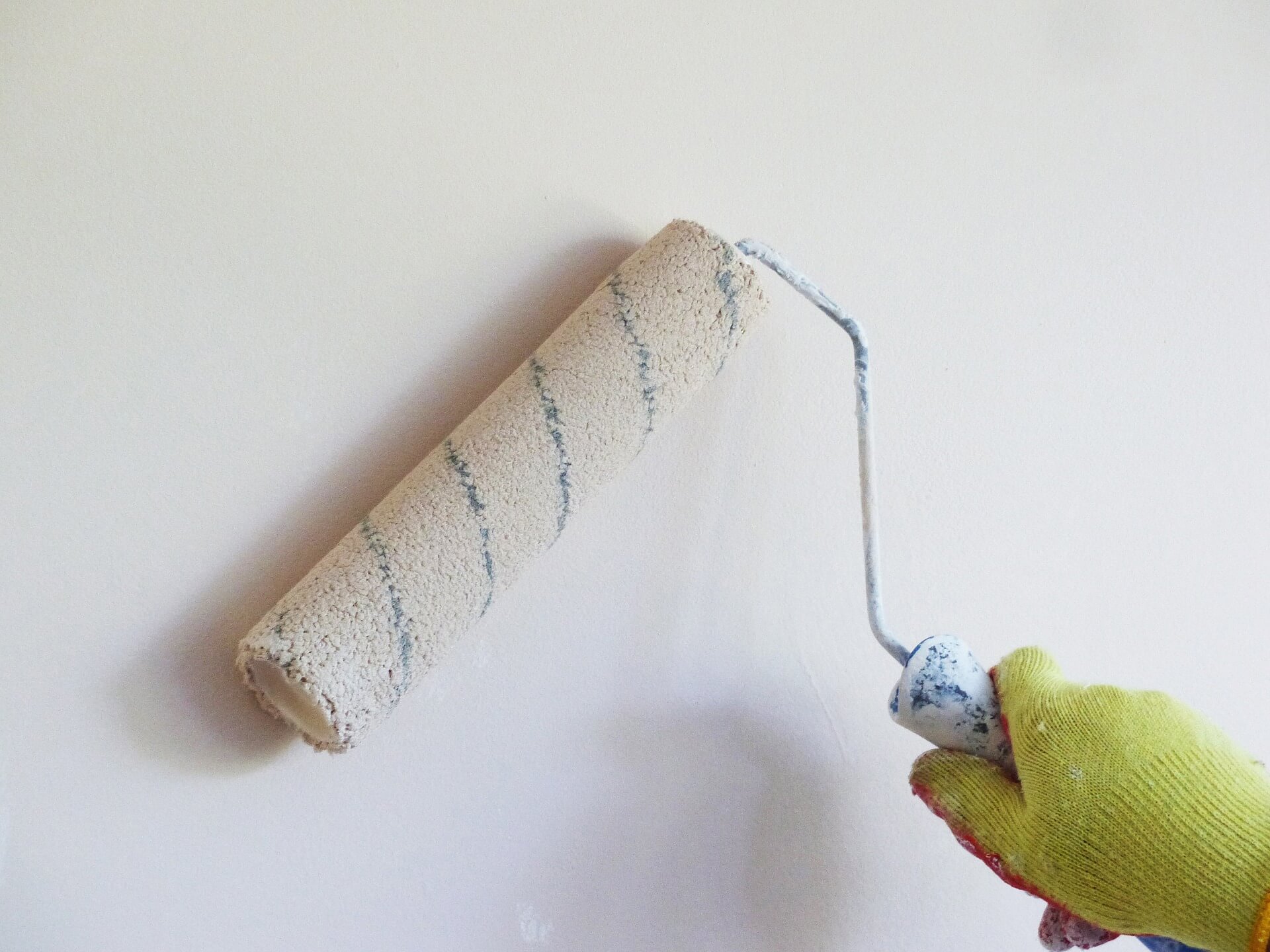 Paint roller on white wall