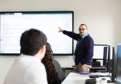 Male Accounting And Professional Studies CPD Student Sat In A Classroom Wearing Glasses