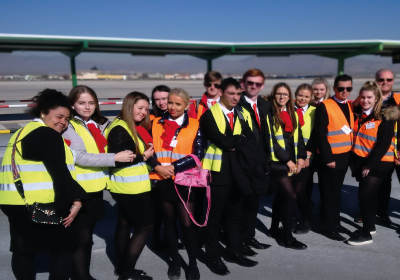 Wirral Met Travel and tourism students at an airport wearing hi-vis vests