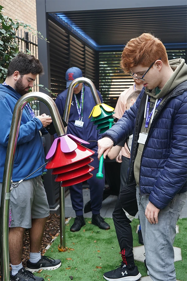 two male students with garden equipment