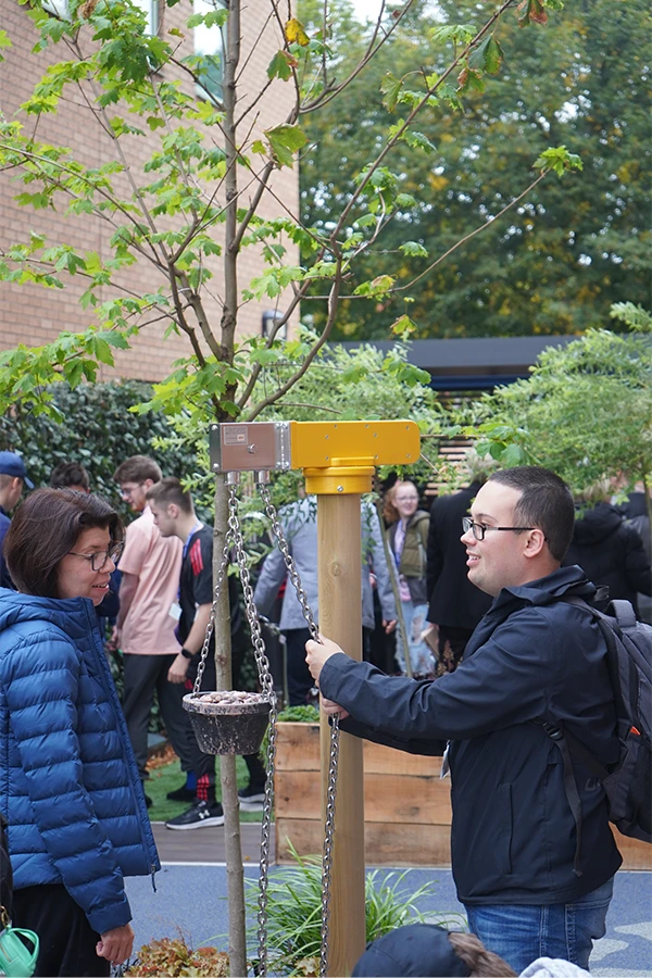 a male student using the garden equipment