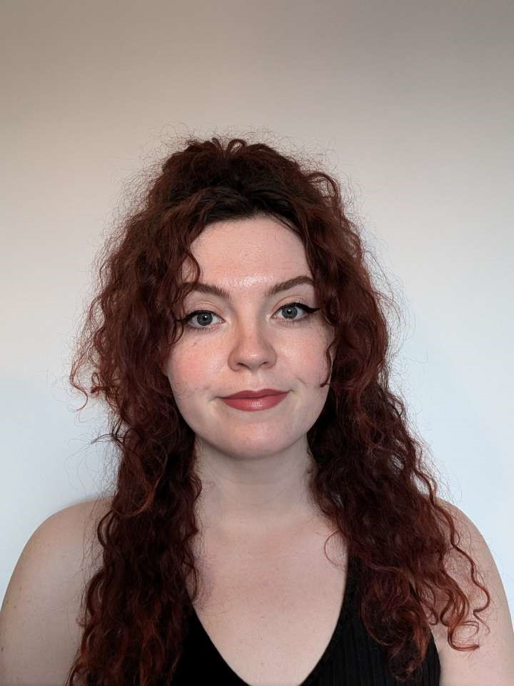 Teacher Training case study Elsbeth Rollinson smiling at the camera whilst standing inside her home