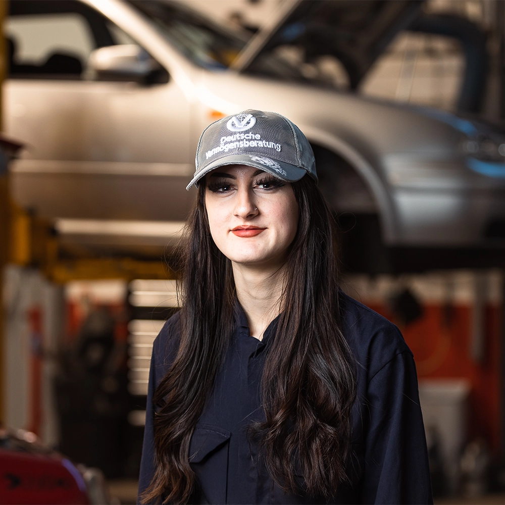 Automotive student Lena standing inside workshop at Twelve Quays