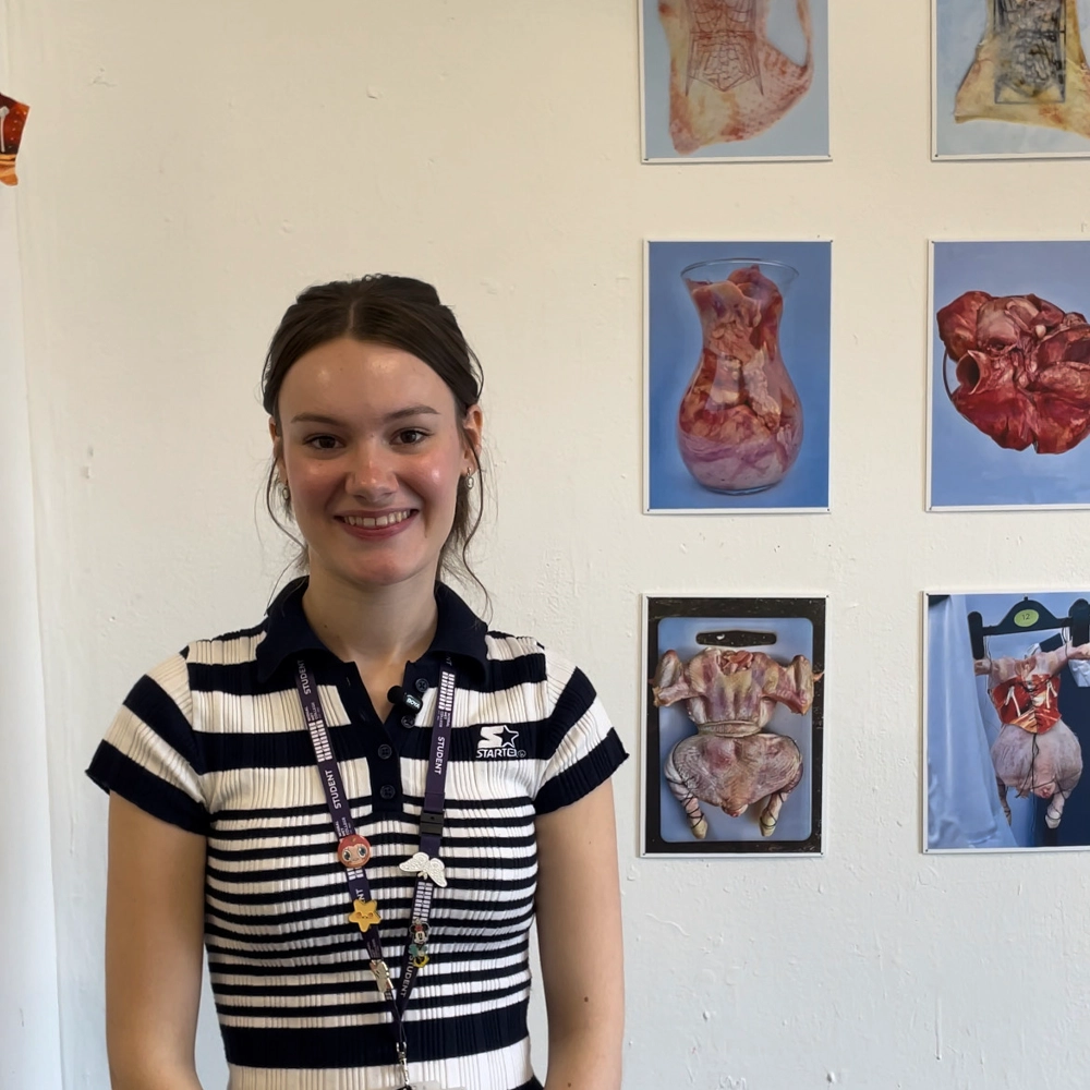 Foundation Art and Design student Lydia Tucker standing in front of her course work