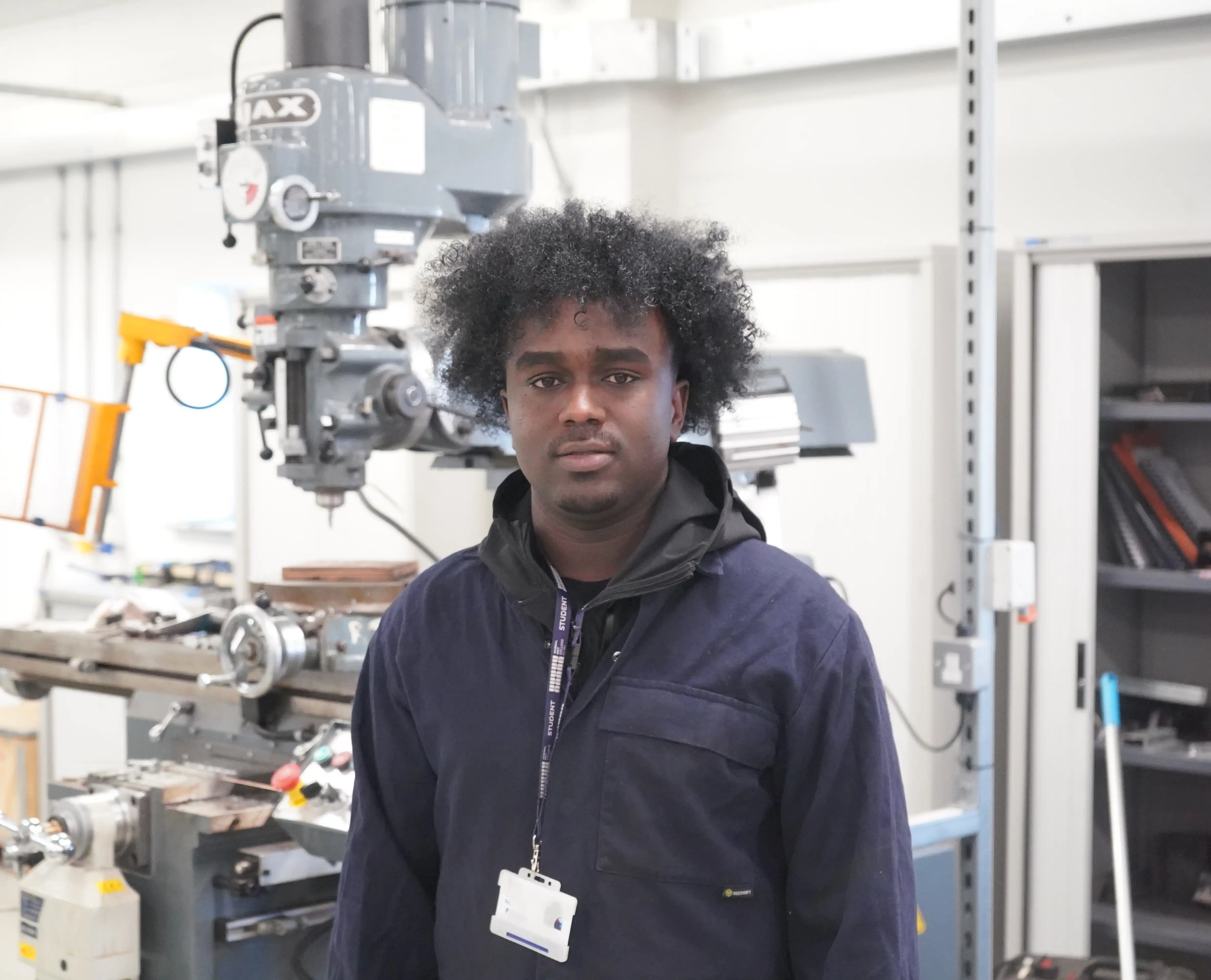 Engineering student Mahamat Nour standing inside Twelve Quays workshop