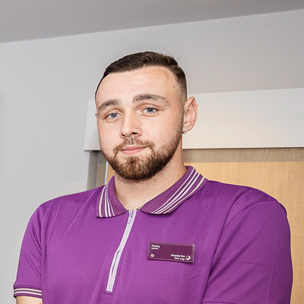 Supported Intern Matty standing inside bespoke Premier Inn training facility at Conway Park