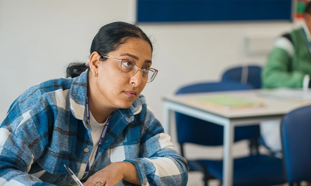 Wirral Met English student studying in the library at Twelve Quays
