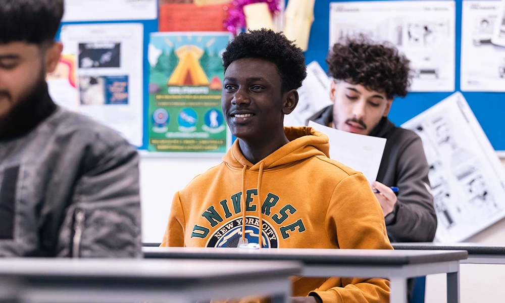 A man sat in a classroom