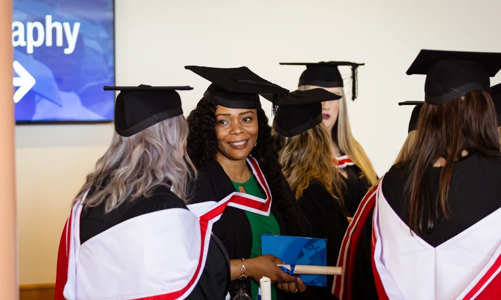 Women stood in a cap and gown. 