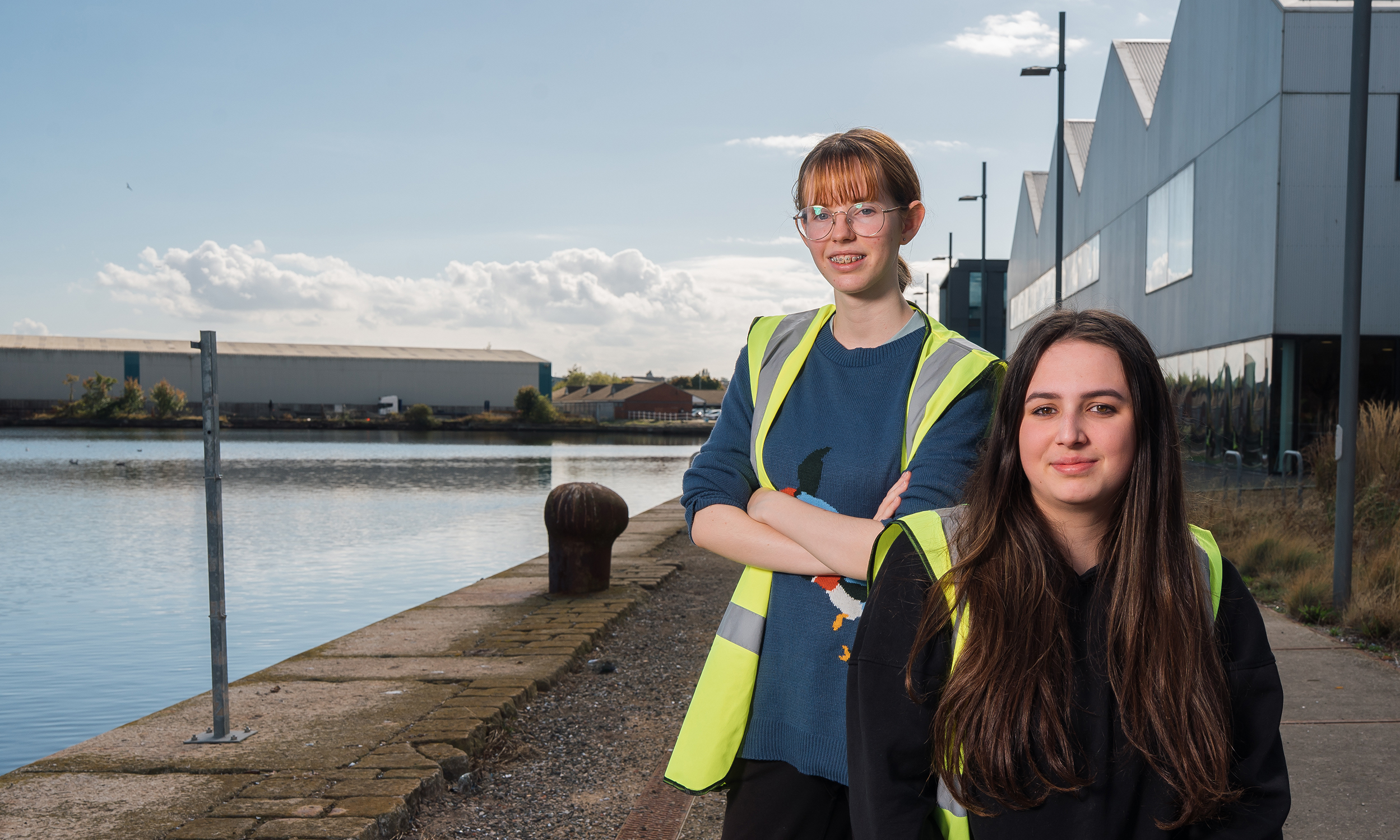 Two female Wirral Met Construction students sitting in front of Wirral Waters campus