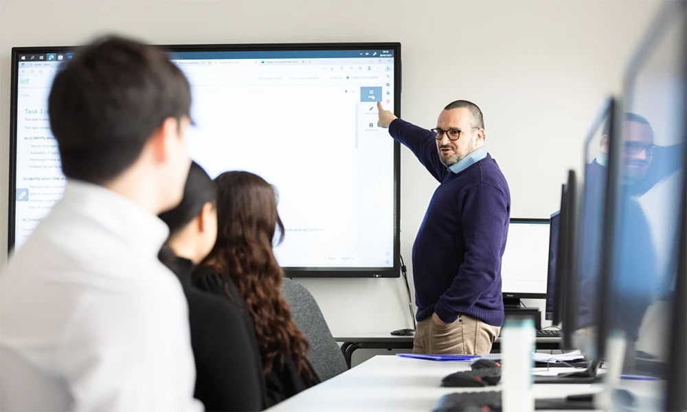 Accountancy lecturer teaching class of students inside of Hamilton classroom