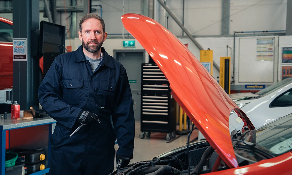 Automotive students working on hybrid car at Twelve Quays workshop