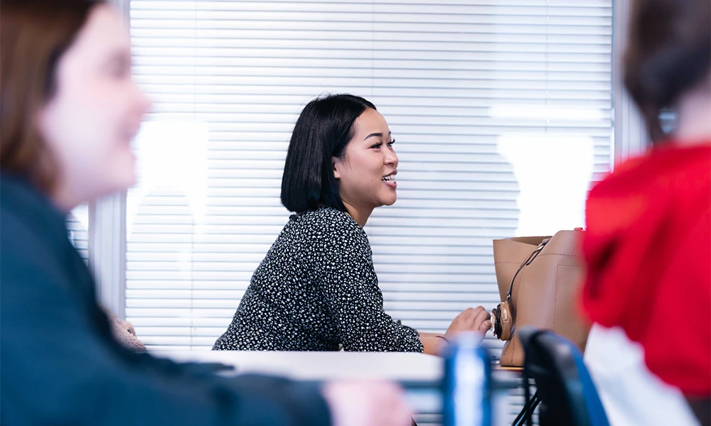 A student smiling in a classroom
