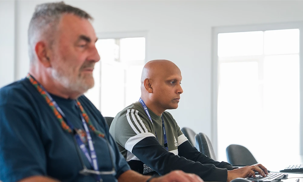 Computing students working inside classroom at Twelve Quays campus