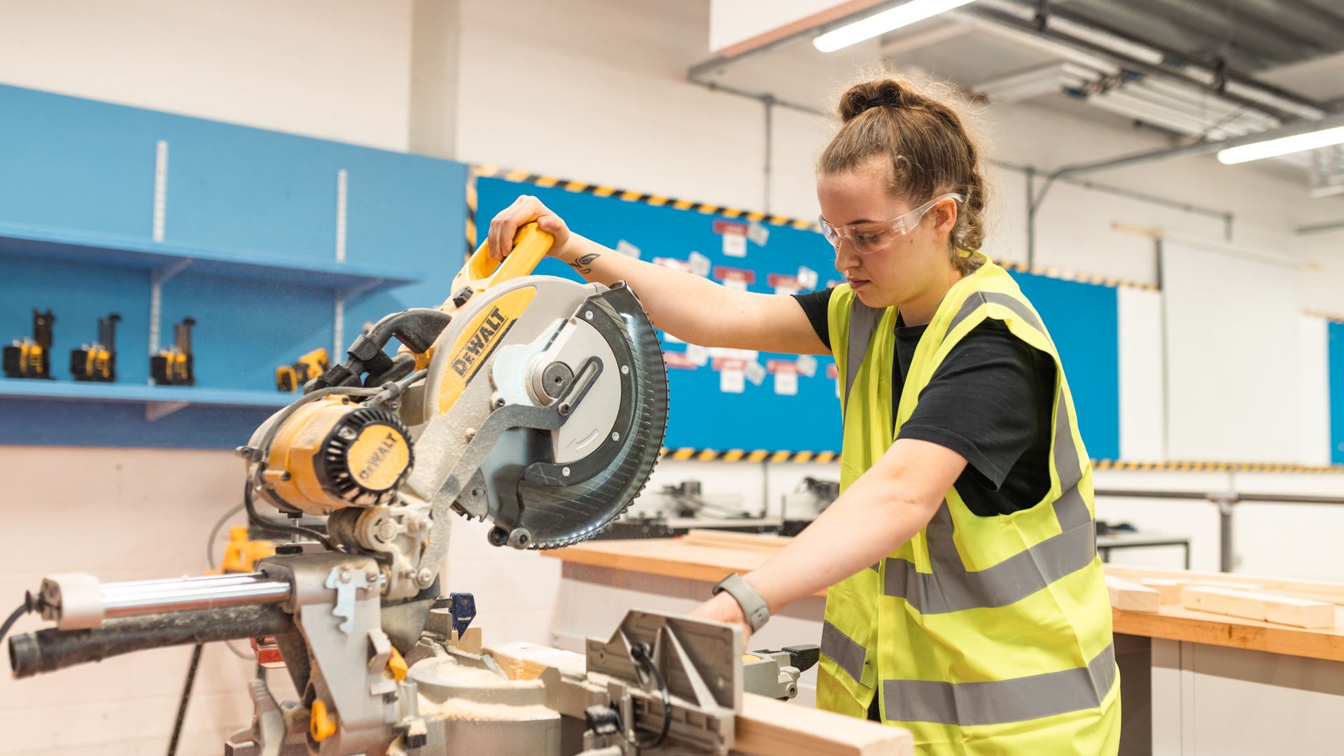 Student working in carpentry room with buzzsaw