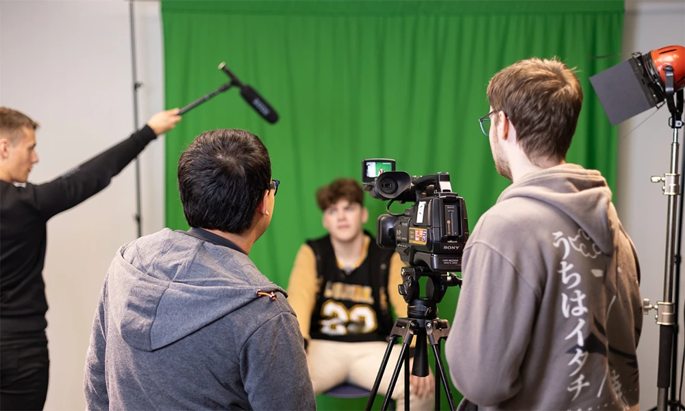 Creative Media students working with industry equipment and green screens