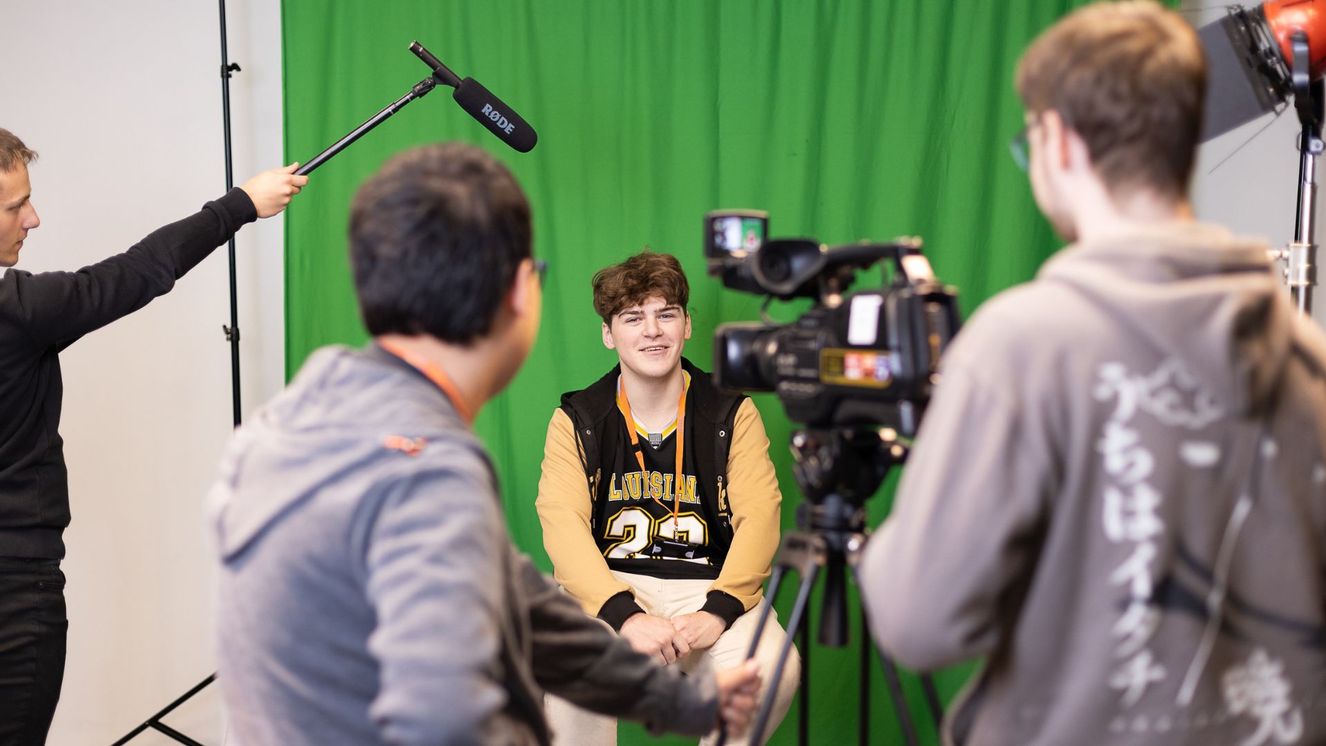 Students filming in green screen studio