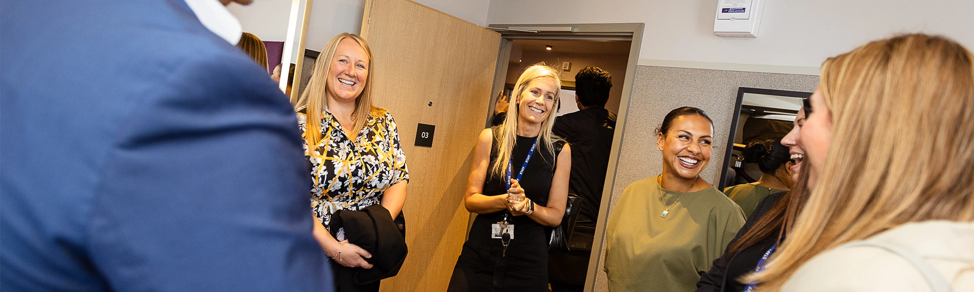 5 people stood smilling