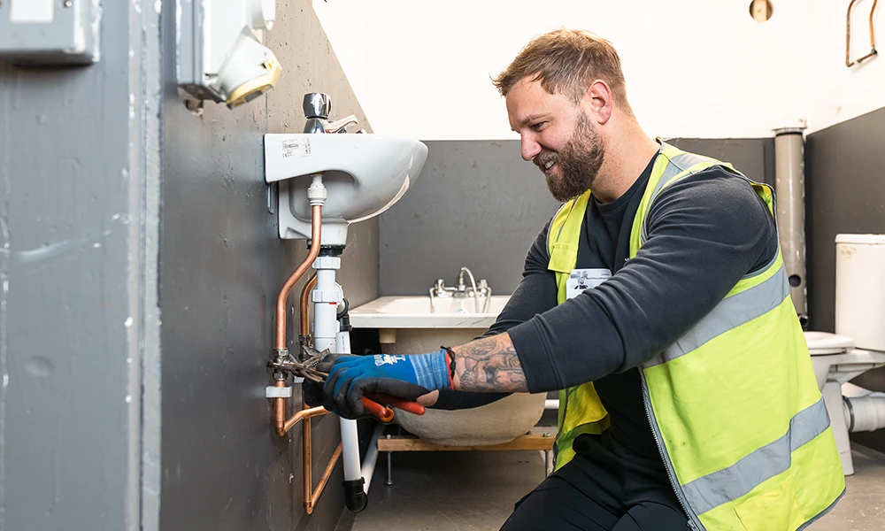 Man in hi vis plumbing