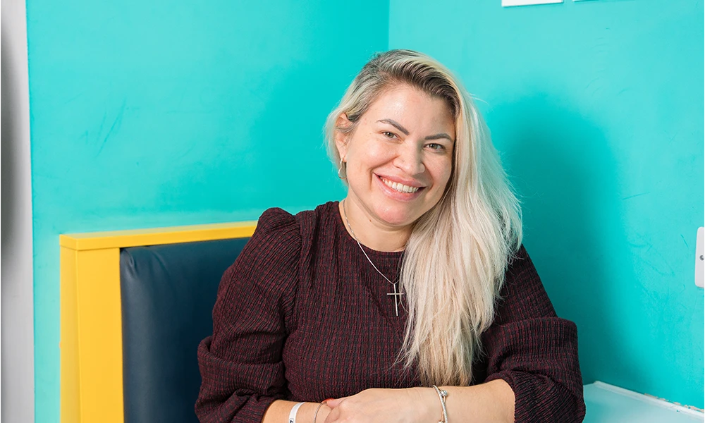 Woman sat on a blue background