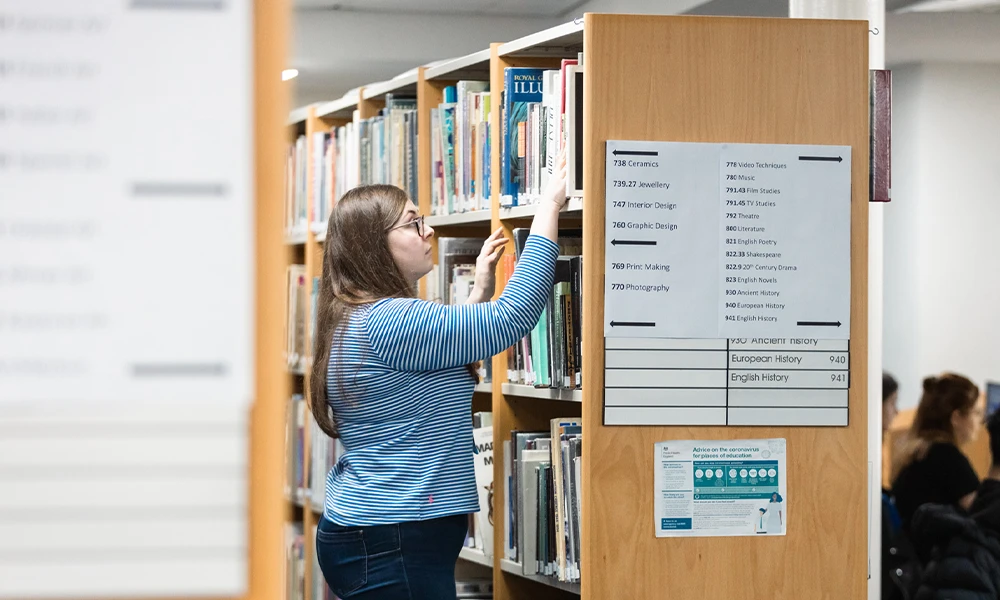 English student using library to find resources at Twelve Quays