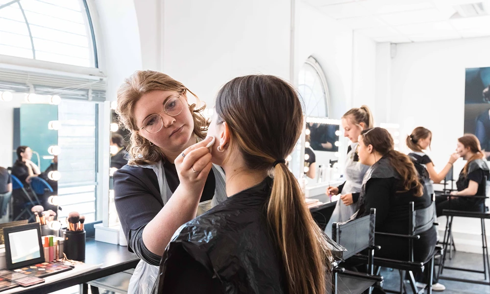 Beauty student applying makeup
