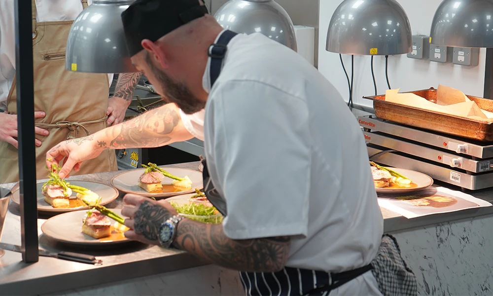 Male student garnishing food plate