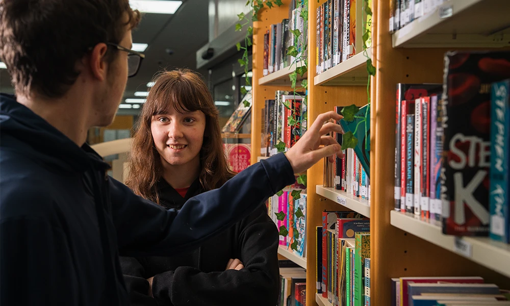 Two Students in a library talking