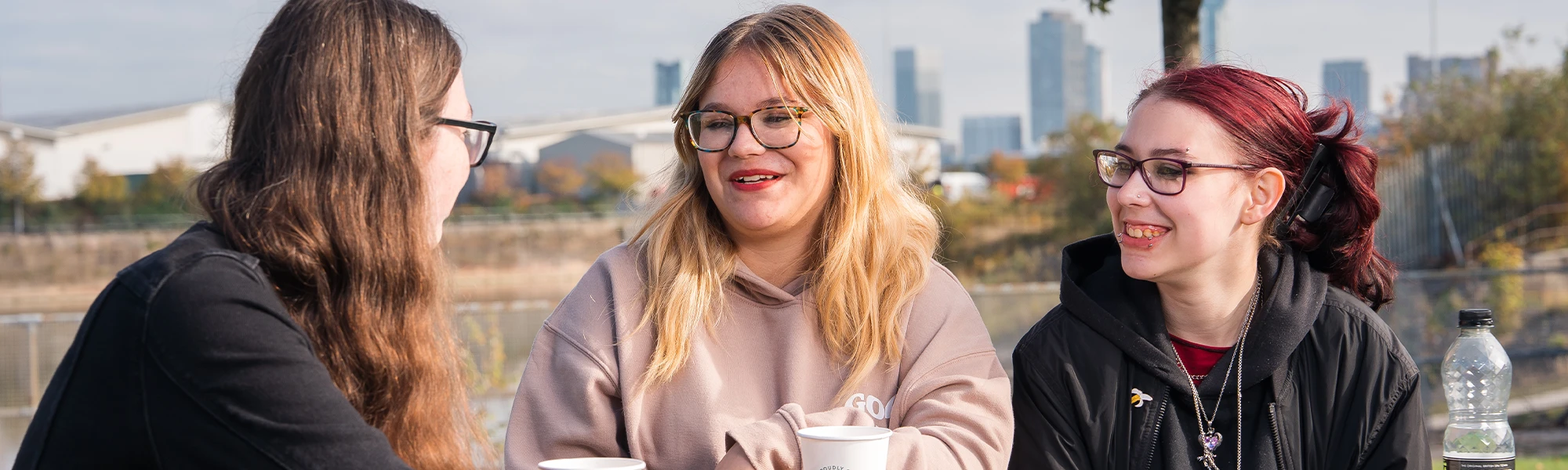 Three girls simling at eachother