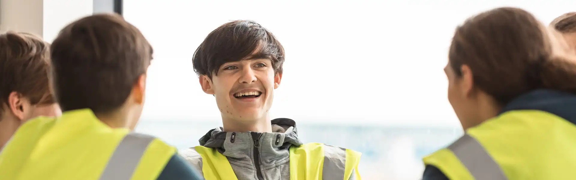 Student sat smiling in a canteen