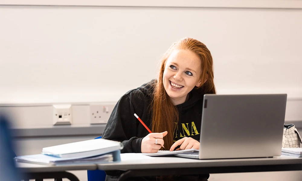 Female Wirral Met student working inside a classroom at the Hamilton campus