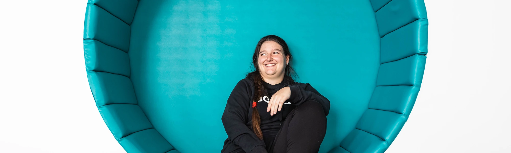 Female Wirral Met student sitting inside Conway Park campus