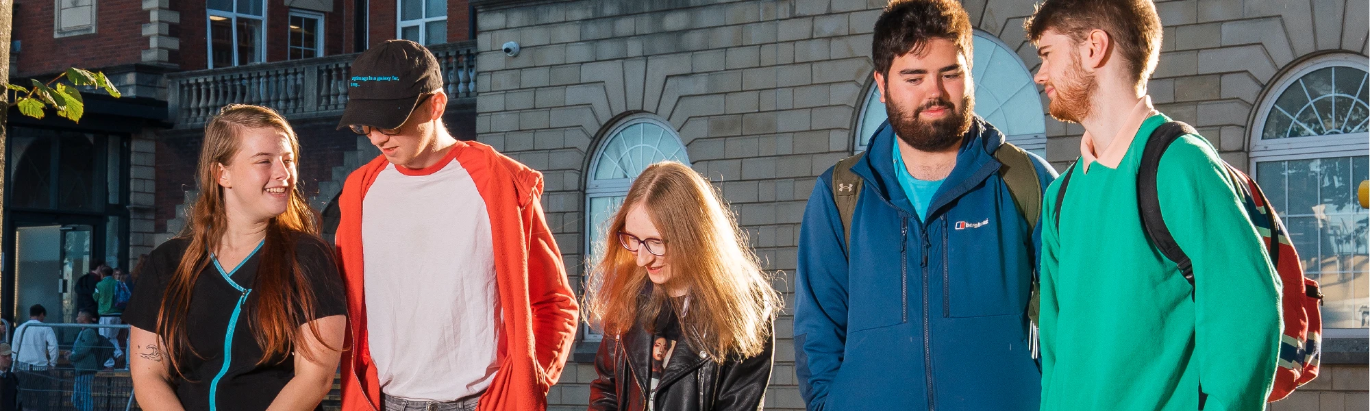 5 students looking at each other walking