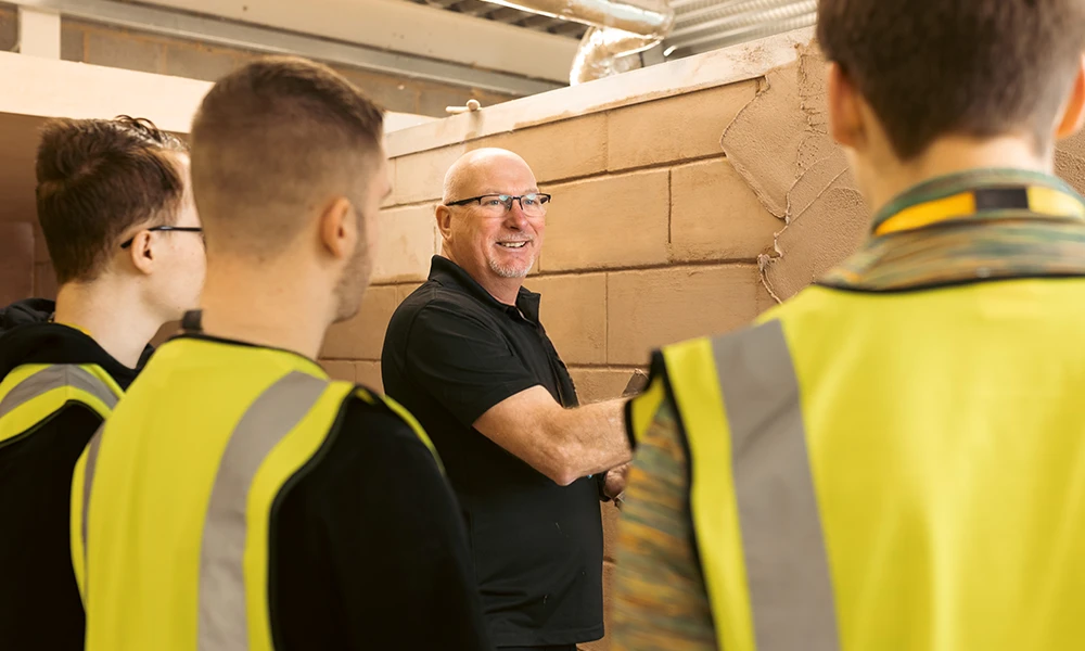 Man teaching plastering