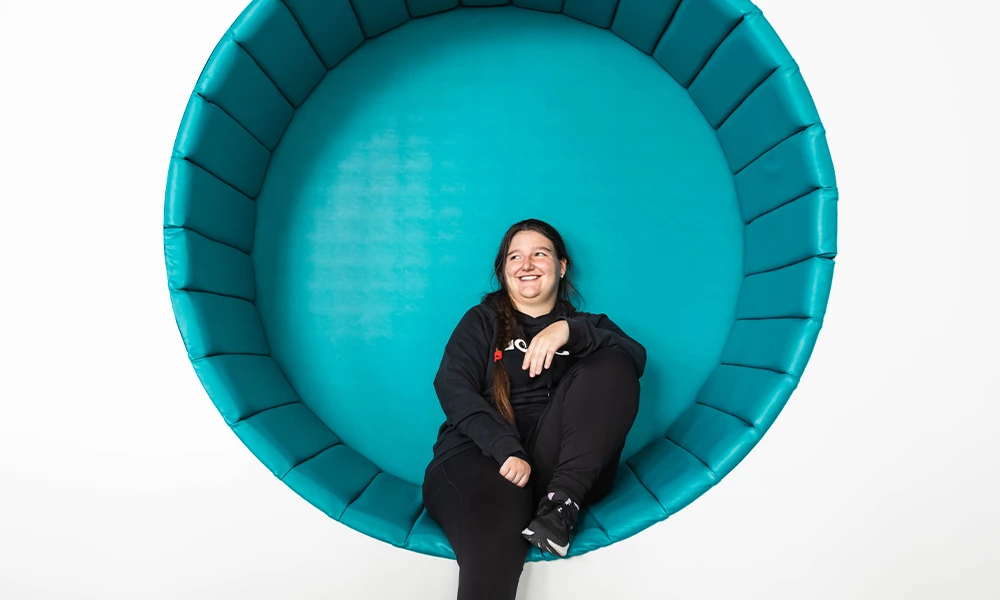 Female Prep For Life student sitting on circular couch at our Independent Living Suite in Conway Park