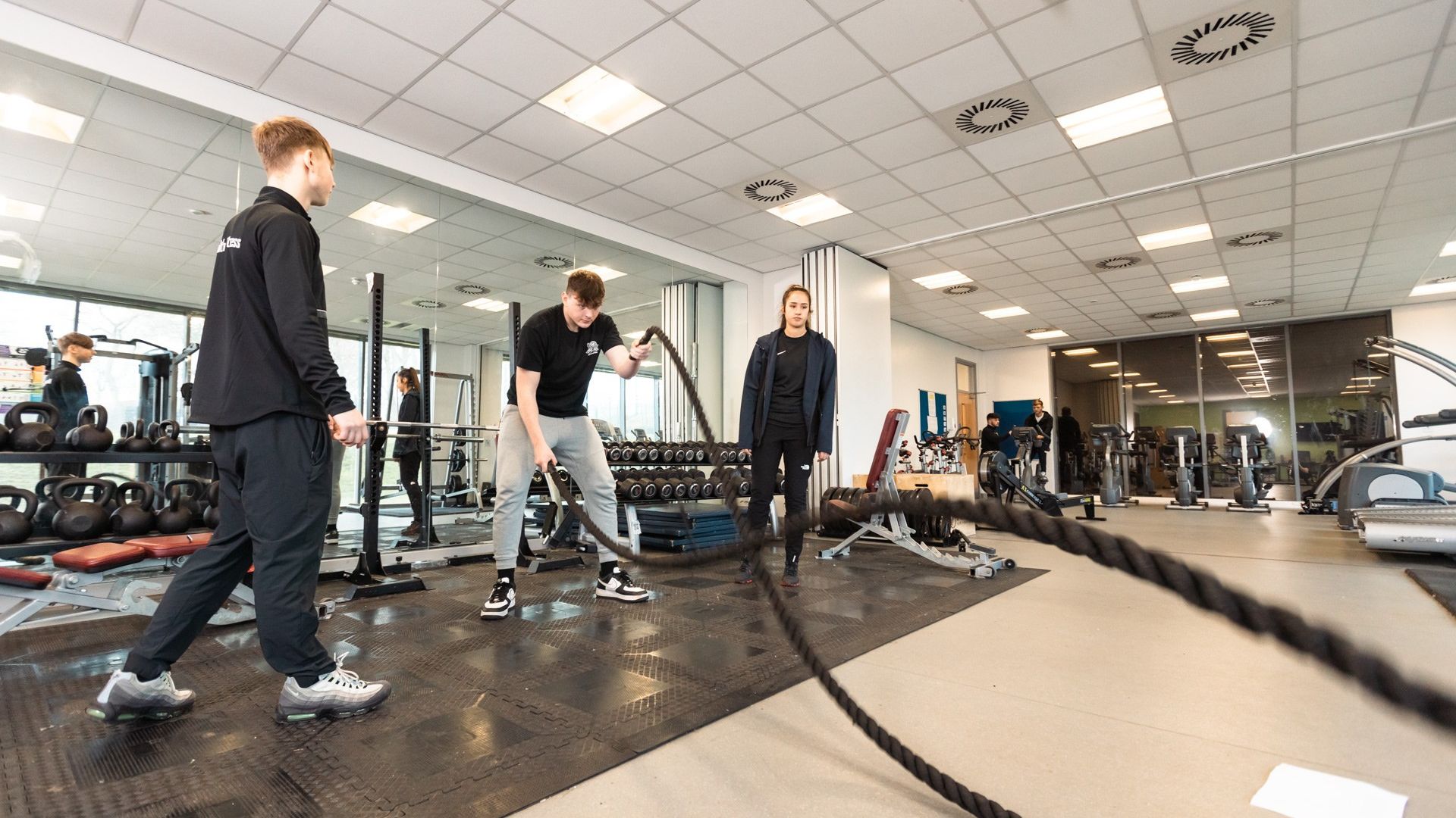 Students using workout ropes in the gym facilities at The Oval