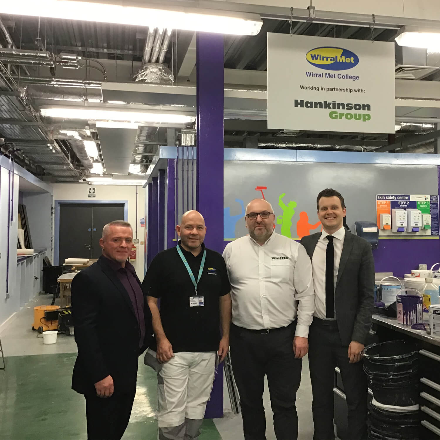 Four men stood in painting and decorating workshop at Wirral Met College