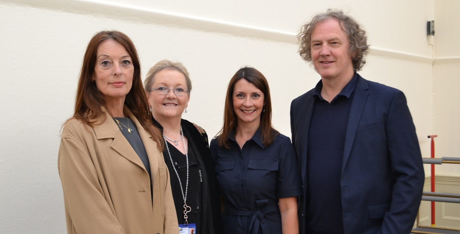 Christian Furr standing in a group photo including Wirral Met's Principle Sue