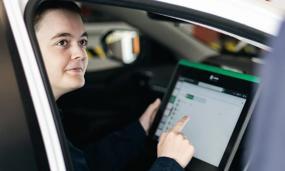 Automotive student working inside electrical vehicle