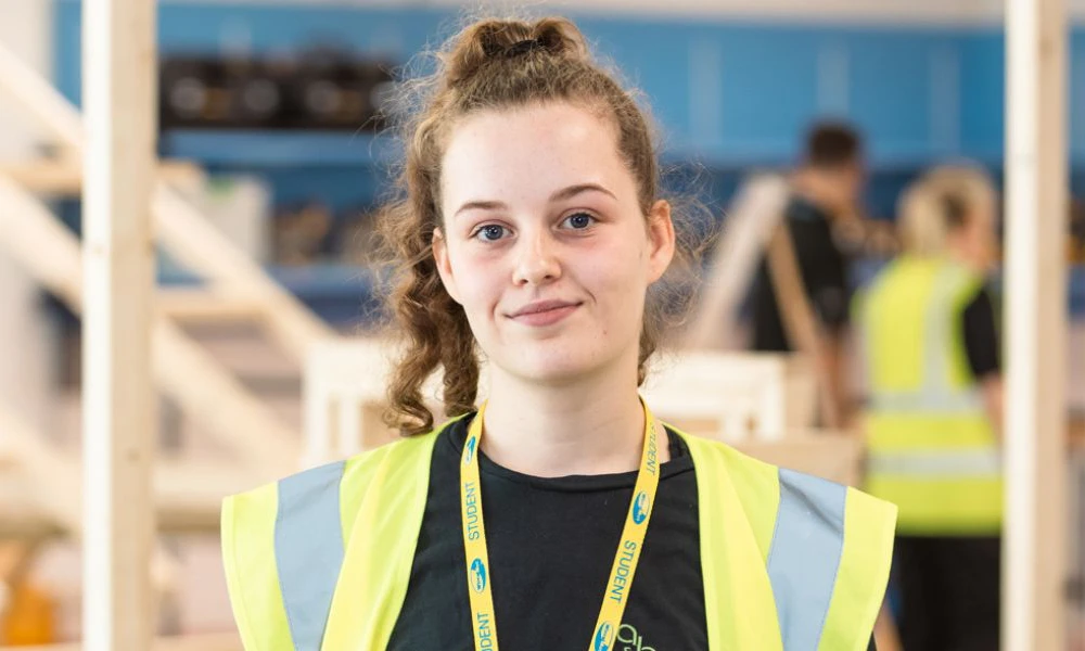 Carpentry student stood inside Wirral Waters construction workshop