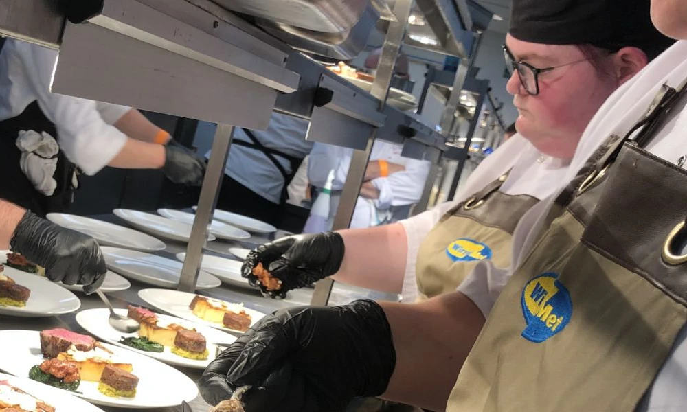 Culinary Arts students preparing dishes at black tie event in Anfield